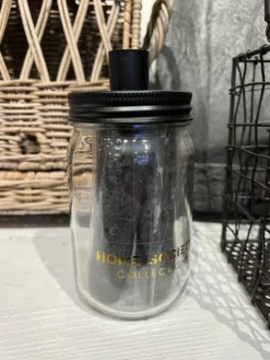 Glazen pot met 3 zwarte kaarsen